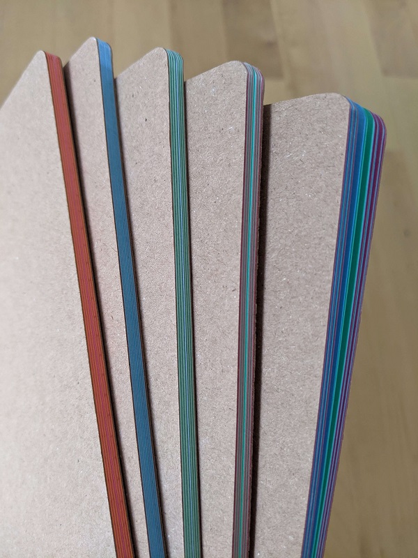 Photograph of A5 notebooks with colourful pages